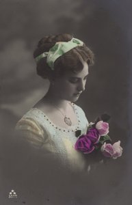 Girl peering into bunch of roses