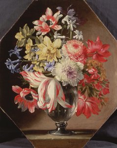 A Glass Vase of Flowers on a Stone Ledge Containing Tulips, Chrysanthemums, Roses and Bluebells