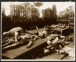 Six Male Models as Ancient Warriors Dressed in Armor Pretending to be Dead by Alphonse Maria Mucha