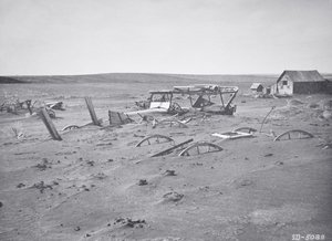 Car and farm machinery buried by dust and sand, Dallas, South Dakota