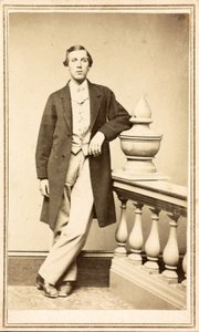 Unidentified man in top coat leaning against pillar, c.1860-75 by American Photographer