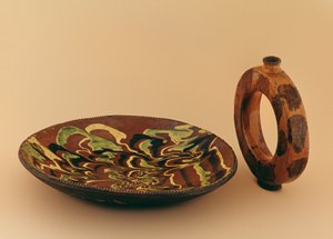 Redware oval dish with marbled glaze and water carrier