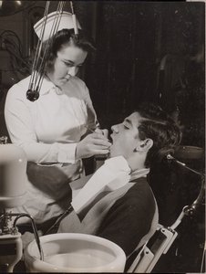 Dental Hygienist Inspects a Patient