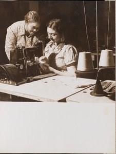 Two Women Use a Sewing Machine by Arnold Eagle