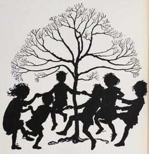 Silhouette of children dancing around a tree