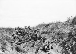 Lieutenant A. V. Sedgwick and some of his party from the 24th Battalion, awaiting the lifting of the artillery barrage on Mont St Quentin, photographed a few minutes before moving out of the trench