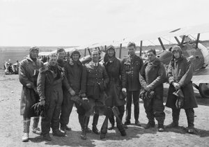 The officers of A Flight, No. 4 Squadron, Australian Flying Corps, in full flying gear in front of line up of Sopwith Camel aircraft, 16 June 1918