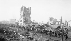 Ypres, Belgium. 18 October 1917. Pack mules taking up supplies with the Infantry. Note the shell damaged buildings in the background, 18 October 1917