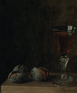 A Glass of Wine with Walnuts on a Table