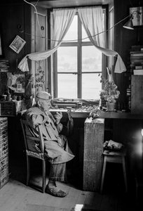 Italian watchmaker with his tools and workbench