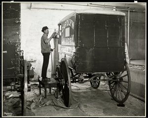 A Man Spraypainting a Delivery Wagon of the Carolyn Laundry at 111 East 128th Street, East Harlem, New York, 1929 by Byron Company