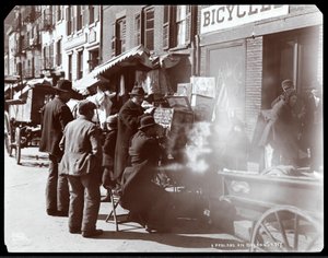 View of Street Vendors, Including One Showing Photographic Views of Exotic Places in a Viewbox, on Bayard Street, New York, 1898