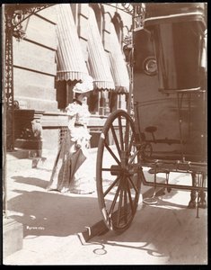 Woman approaching a carriage at the Waldorf Astoria Hotel, 34th Street and 5th Avenue, New York, 1897 or 1898