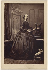 Unidentified woman holding a book, standing