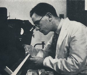 Research worker with microscope testing the structure of an aluminium alloy, 1941 by Cecil Beaton