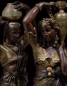 Detail of two bronze torcheres in the shape of Indian women carrying vases