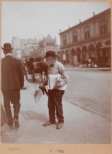 A man standing on the sidewalk of Broadway between 34th St. and 35th St. holding The Evening Telegram newspaper
