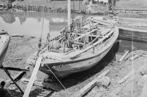 A Twaqo type junk dried out on shore at Singapore