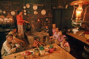 A family sits together before dinner. Tenggerese, Java, Indonesia