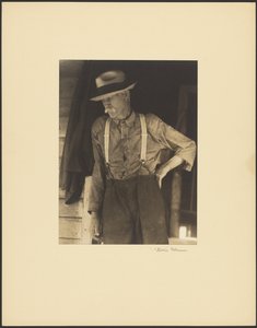 Mustached Old Man with Straw Hat and Suspenders Standing in Doorway by Doris Ulmann