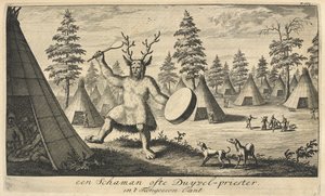 A shaman wearing a headpiece made of the antlers of a reindeer, in a Siberian village, published in Amsterdam