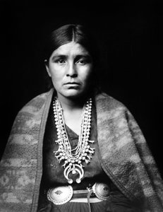 Navajo woman wearing silver squash blossom necklace, concho belt, blanket draped over shoulders, photo Edward S. Curtis by Edward Sheriff Curtis