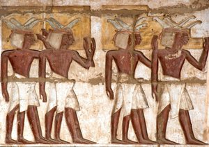 Egyptian antiquity: first court, detail of painted reliefs representing a group of Nubians bringing offerings to the pharaoh. Funeral Temple of Ramses III