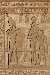 Egyptian Antiquity: Roman Mammisi Commemorating the Birth of Ihy, Son of Hathor - Detail of Reliefs and Hieroglyphs: the Goddess Isis - Hathor Nursing Her Son Ihi (Ihy) and Behind Her Another Image of Ihi with a Finger in Her Mouth Indicating that it is a  by Egyptian Ptolemaic Period