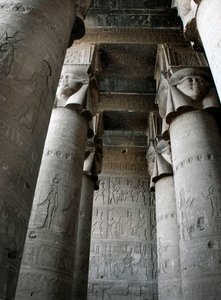 Partial view of the hypostyle room with columns decorated with the representation of the goddess Hathor. Temple of Hathor, Denderah, Egypt by Egyptian Ptolemaic Period
