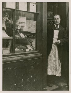 A Shopkeeper Standing in the Doorway of His Shop by English Photographer