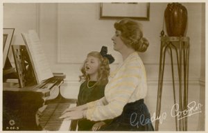 Gladys Cooper and girl at piano by English Photographer