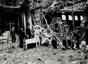 King George VI and Queen Elizabeth, together with Winston Churchill, surveying bomb damage, presumably to Buckingham Palace by English Photographer