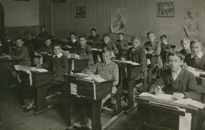 Male Pupils Sitting Behind Their Desks During a Lesson at School