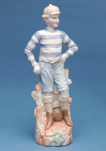 Bisque figure of a boy footballer in blue and white striped kit (ceramic)