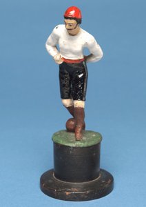Footballer with the ball at his feet by English School