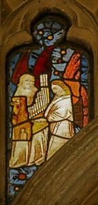 Window depicting musician angels, one with a portative organ