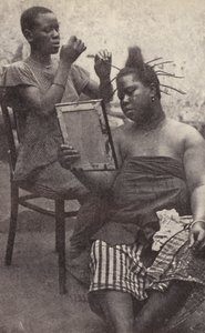 West African Woman Having Her Hair Done (b/w photo) by European Photographer