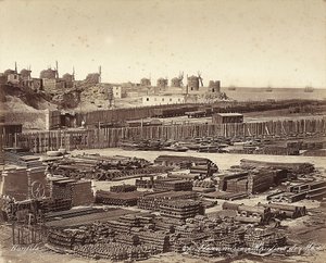 Yard for construction materials, windmills are in the background, in Alexandria, Egypt