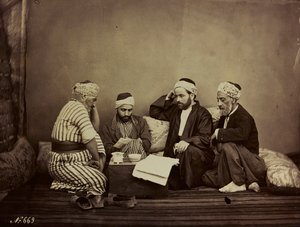 Album Damas et Baalbek: A group of Syrians sitting around a table by Félix Bonfils