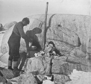 Forde Cooking Seal-Fry on the Blubber Stove at Cape Roberts, c1911, 1913