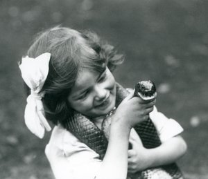 A Young Girl Betty Holding an Eastern Indigo Snake, London Zoo, 1924 by Frederick William Bond