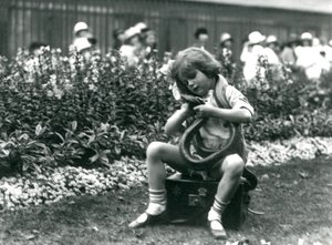A Young Girl Betty Holding an Eastern Indigo Snake, While Sitting on a Leather Trunk, London Zoo, 1924