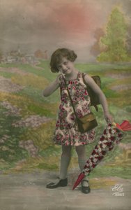 Girl in floral dress, carrying cone decorated with flowers
