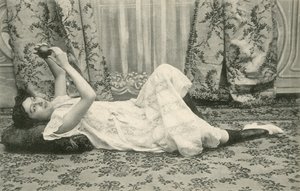 Girl, lying on the floor, holding a ball above her head by French Photographer