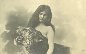 Long-haired girl with arms around stuffed leopard by French Photographer