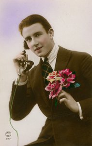 Man on the telephone, holding flowers