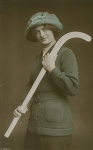 Young woman carrying a hockey stick over her shoulder
