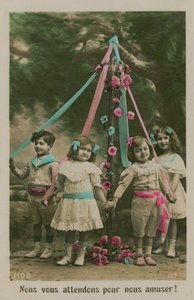 Children standing around a maypole (hand-coloured photo)