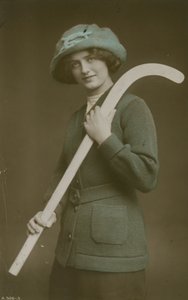 Young woman carrying a hockey stick over her shoulder