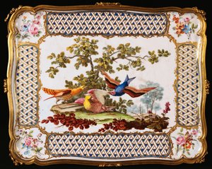 A Louis XV Sevres tray decorated with three exotic birds in a landscape, forming the top of a table a cafe